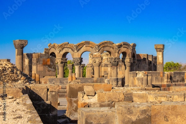 Fototapeta Columns and unique stone ruins of the ancient medieval Zvartnots temple. Vagharshapat Famous landmark constructed in the 7-th century in Armenia. Museum and archaeological site. Yerevan. Europe.