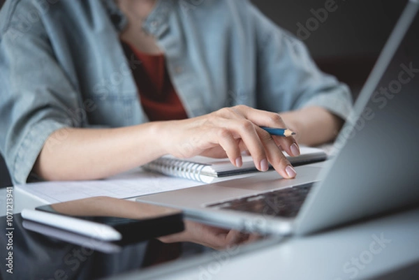 Obraz Close up, woman hand typing on laptop computer keyboard. Business woman online working on laptop computer, surfing the internet, searching the information at home office, e-learning