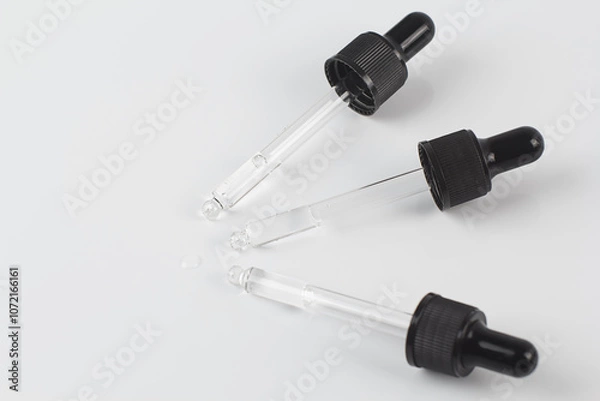 Obraz Pipettes with liquid on a white background