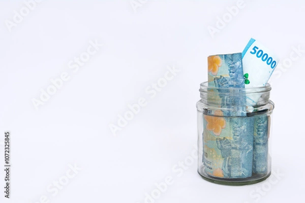 Fototapeta some bills rupiah in a clear jar