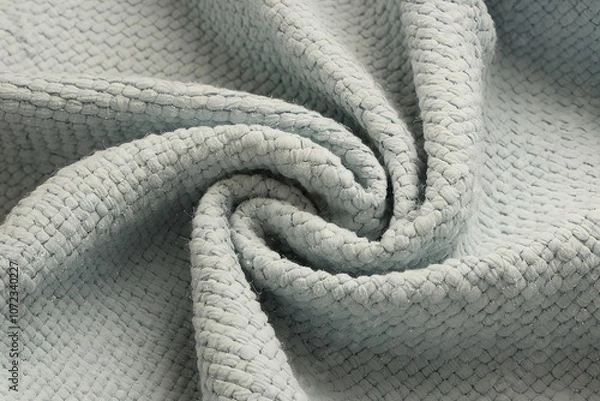 Fototapeta A close-up photo of a textured fabric with a light blue hue