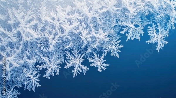 Fototapeta Close-up of intricate ice crystals and snowflakes on a cold blue background, delicate winter frost macro with detailed frozen patterns
