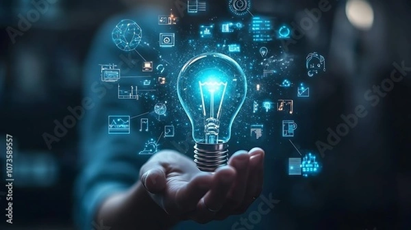 Fototapeta Hand holding an illuminated light bulb with digital icons, Business idea light bulb with technology icon