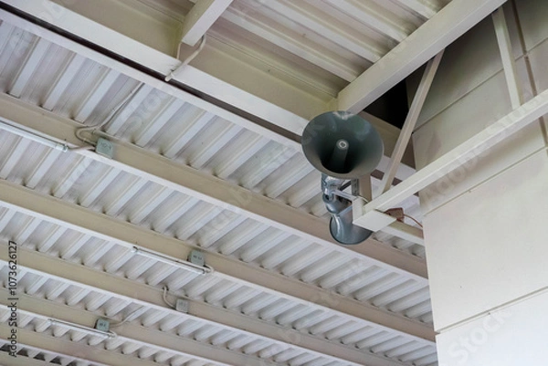 Fototapeta Public address system hanging from metal ceiling structure