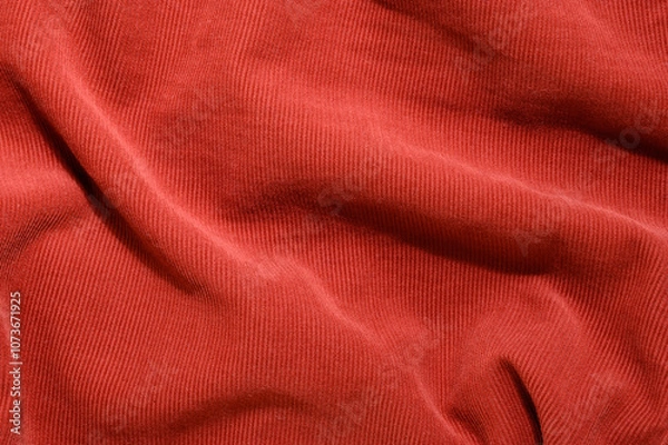Fototapeta Vibrant red velvety fabric texture with soft ribbed details and folds