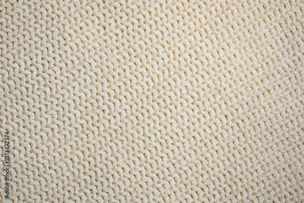 Fototapeta Textured white creamy knitted fabric with a soft, cozy finish.