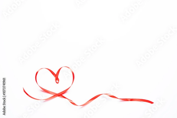 Fototapeta Red heart-shaped ribbon on a white background
