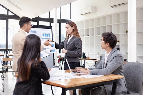Obraz Asian business teamwork working with analysis report and advisor showing plan, Financial analysis and Marketing teamwork concept.