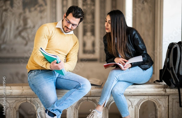 Fototapeta Two students studying indoor in a university open space