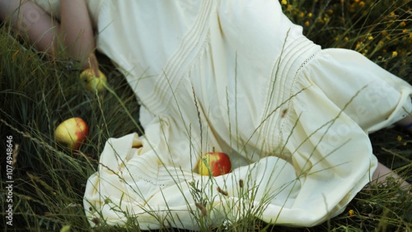 Obraz Crop picture of a girl in yellow dress  in the grass.