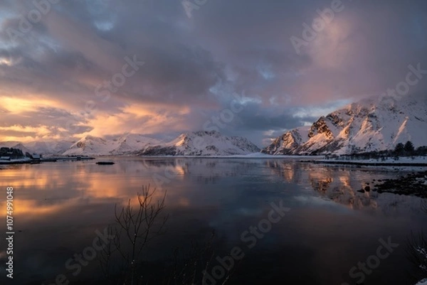 Fototapeta Snowy mountains reflecting in sunset