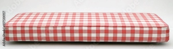 Obraz A red and white checkered cushion, suitable for seating or decor.