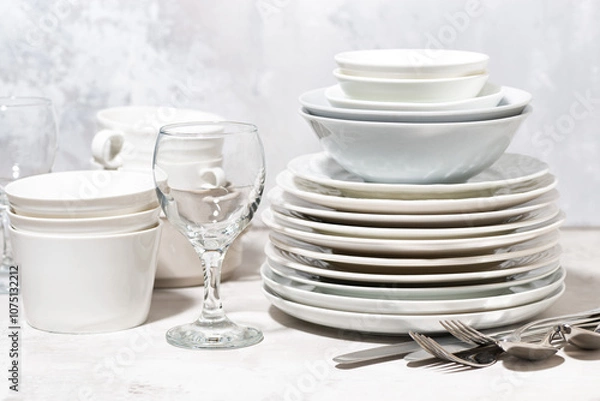 Obraz tableware, cutlery and glasses on a white background, closeup