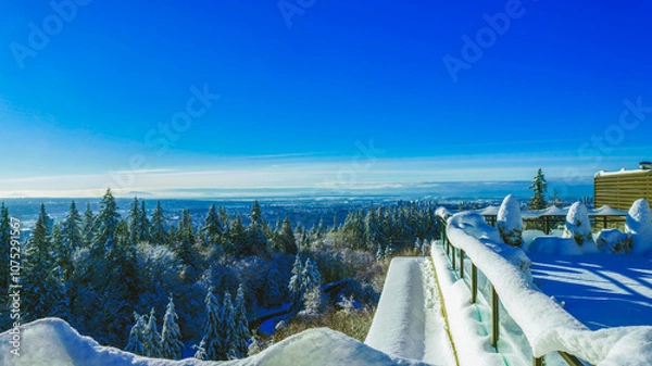 Fototapeta Snowbound rooftop patio overlooking spectacular Fraser Valley, BC, Canada winter scenery.