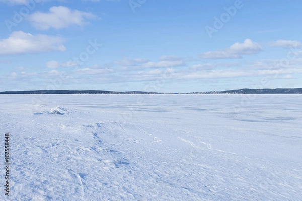 Obraz View of frozen northern lake on a clear winter day 