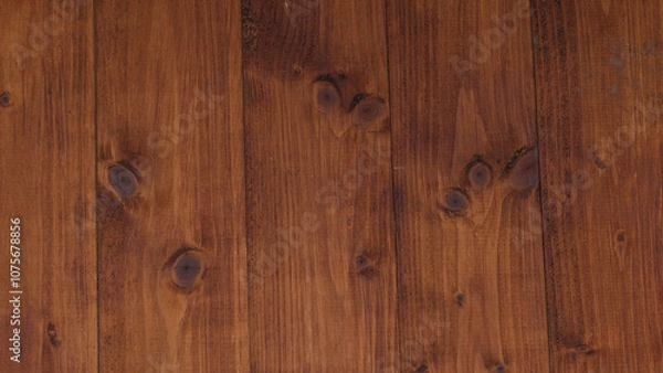 Fototapeta Close-up view of a dark wooden panel featuring unique knots and a rich, deep brown texture that enhances its natural and sophisticated appearance