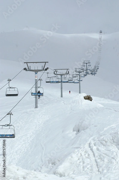 Obraz Ski. Lift in the snowing High Mountains. Clouds. Wide landscape