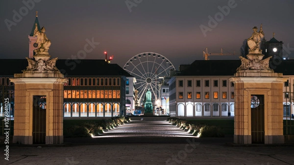 Fototapeta Night panorama of Karlsruhe with the view of the Ferris wheel from the avenue of the city park. Karlsruhe, Germany, Baden-Württemberg.
