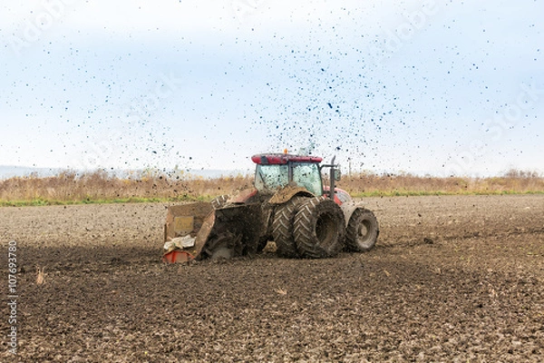 Fototapeta Tractor with double wheeled ditcher digging drainage canal