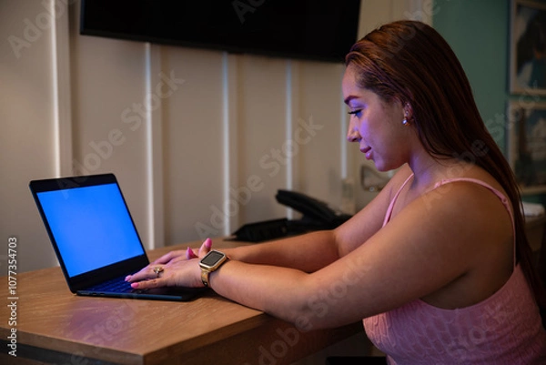 Fototapeta Beautiful latin woman typing on keyboard laptop sitting at desk