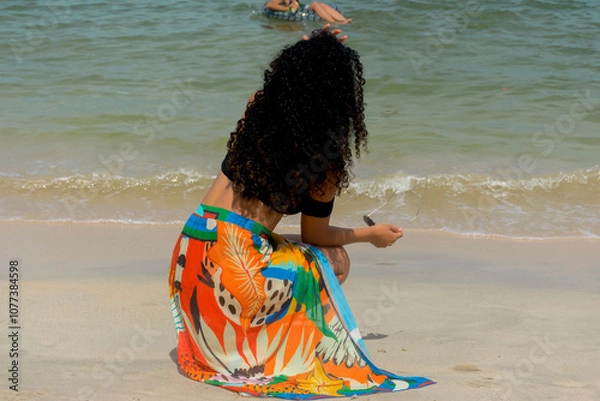 Obraz Latin woman with colorful skirt having fun looking at the sea. 