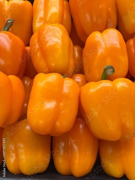 Obraz Orange peppers (capsicum) on display 