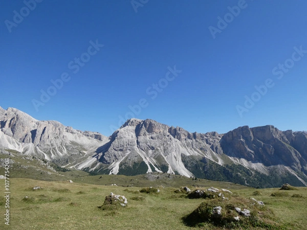 Fototapeta landscape in the mountains, Blue skies on a summers day in Europe Alpine region. Hiking hut-to-hut in the Dolomites. 