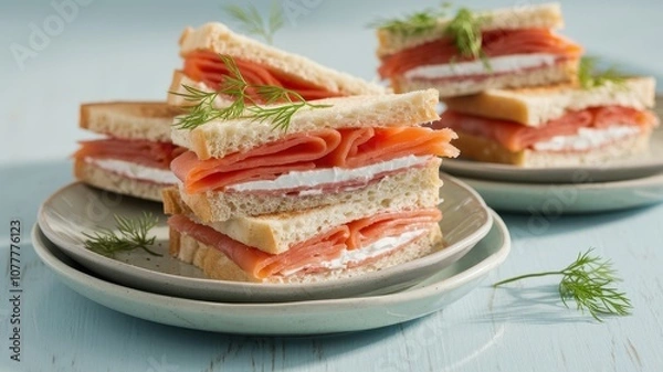 Fototapeta Stack of Open-Faced Smoked Salmon Sandwiches with Herb Garnish on Blue