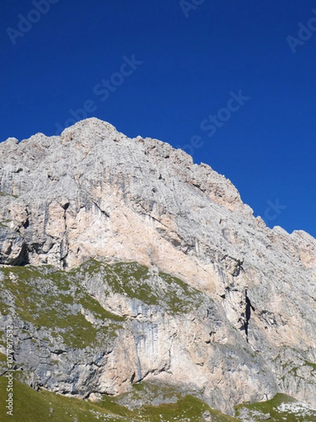 Fototapeta landscape in the mountains, Blue skies on a summers day in Europe Alpine region. Rocky cliff face.