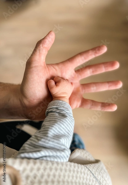 Obraz Heartwarming Connection of Baby and Parent Holding Hands - Family Bond and Love Concept