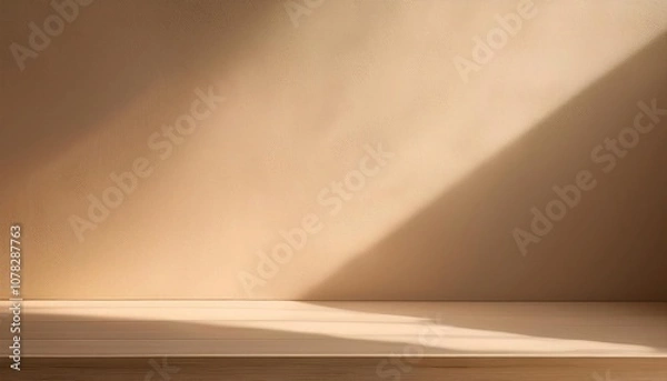 Fototapeta Soft warm-toned wall with natural morning light and faint golden glow.