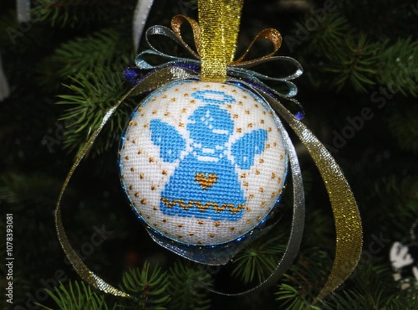 Obraz Christmas ball with Ukrainian style angel embroidery hanging on the tree  