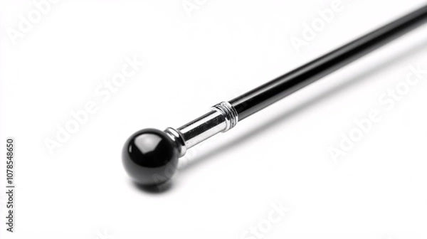 Fototapeta Elegant black cane with silver detail and round handle on white background. Classic design, symbol of power, luxury, and vintage style. Perfect for fashion and mobility.
