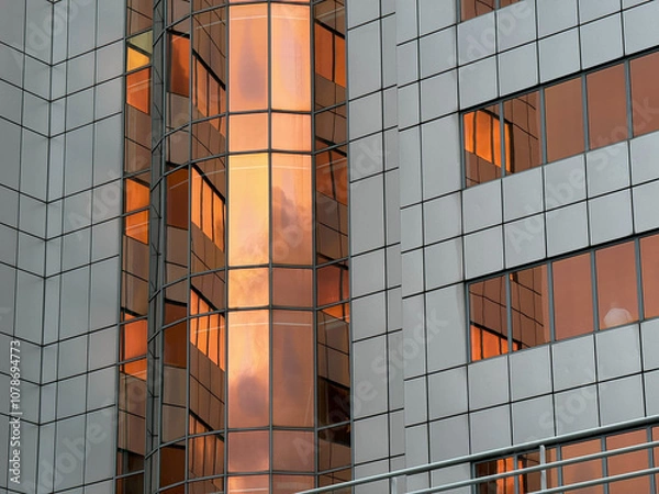 Fototapeta Modern Building with Reflective Orange-Tinted Windows