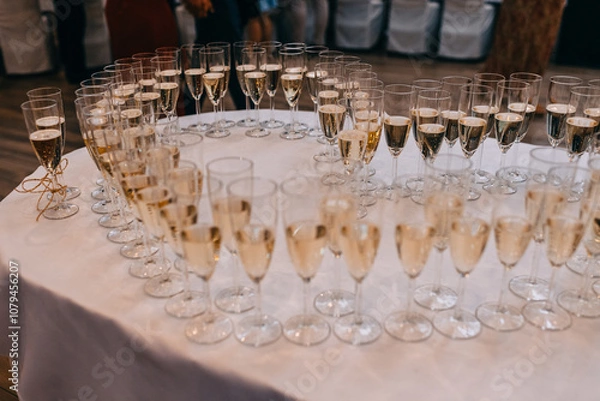 Obraz Champagne glasses arranged in heart shape during the wedding