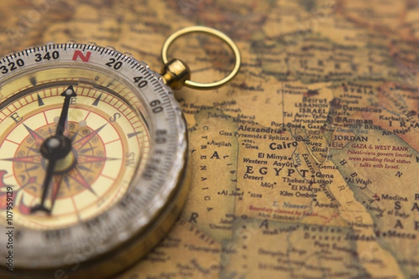 Obraz Old compass on vintage map selective focus on Egypt