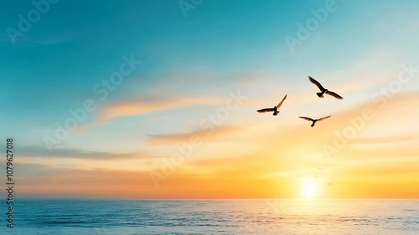 Fototapeta Serene sunrise over the ocean horizon with birds silhouetted against the vibrant sky symbolizing freedom new journeys and hope for the future