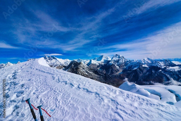 Fototapeta View of Summit ridge of Mera Peak central,6461 m,with a climbers hiking poles and background panorama of Mount Makalu and Everest on a clear October morning,Mera Peak Expedition,Nepal 
