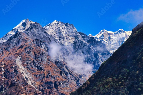 Fototapeta Magnificent view of Mera Peak North,6476 m and Central summit,6461 m on the right of frame from Kothe village,Makalu Barun national park,Nepal 