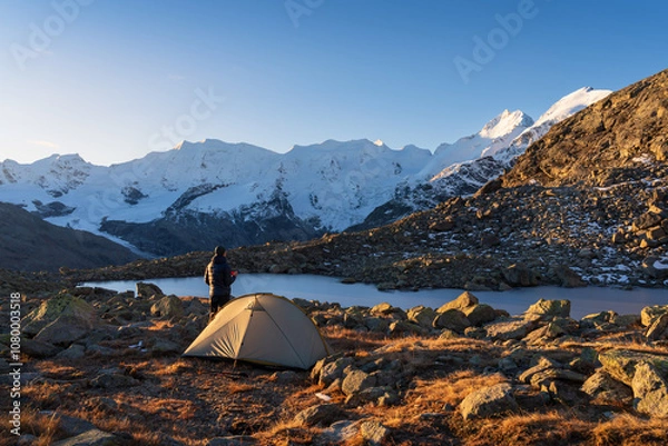 Fototapeta A hiker enjoying his coffee at a beautiful campsite in the Bernina mountain range. Switserland.