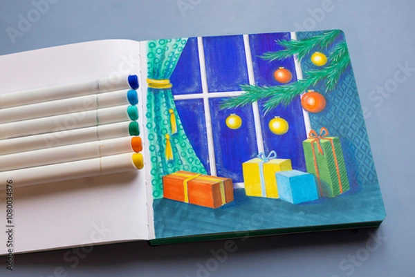 Fototapeta Drawing with markers in a sketchbook on the Christmas theme - a Christmas tree with decorations and gifts