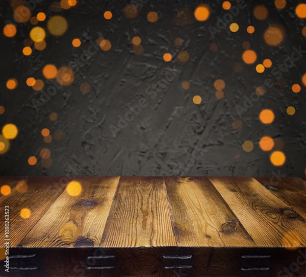 Fototapeta Festive, Christmas, New Year background. Evening. Night. Homely, cozy background. Abstract background. An empty wooden table. Golden lights. Garland. Defocus lights. Bokeh. Copy space
