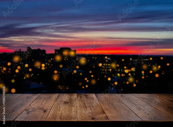 Fototapeta Background. Backdrop. An empty wooden table against the background of the night city. Sunset. Wooden surface. The urban landscape. The lights of the night city.  Light in the window, defocus lights.