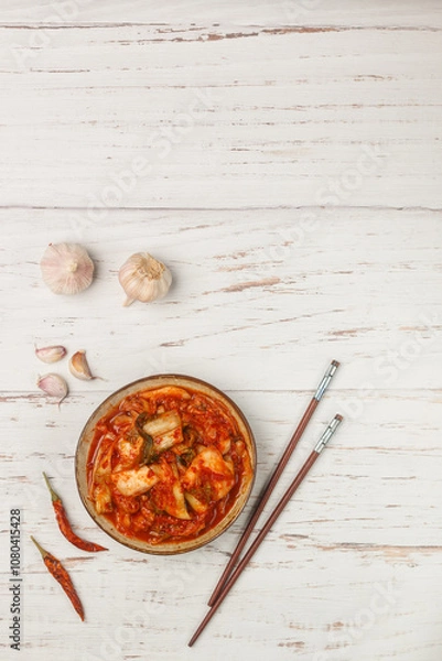 Fototapeta Kimchi is a dish of Korean cuisine made of cabbage and pickled (fermented) vegetables with red hot pepper and garlic. Close-up, selective focus