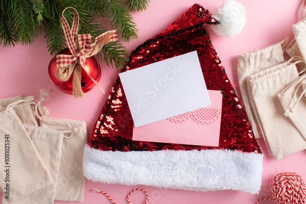 Fototapeta A postcard with pink envelopes, an Advent calendar and festive Christmas decorations on a light pink background