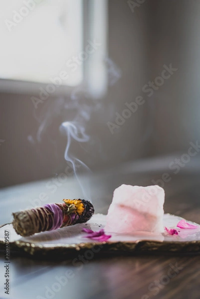 Obraz burning sage stick with smoke on platter with rose quartz