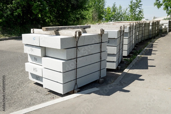 Fototapeta Tile blocks on pallets lie on the road. Сoncrete slabs on pallets.
