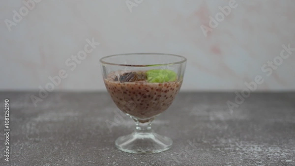 Fototapeta Tapioca pudding on coconut milk with chia seeds and meringue in a mango glaze