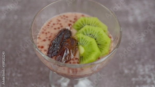 Fototapeta Tapioca pudding on coconut milk with chia seeds and meringue in a mango glaze