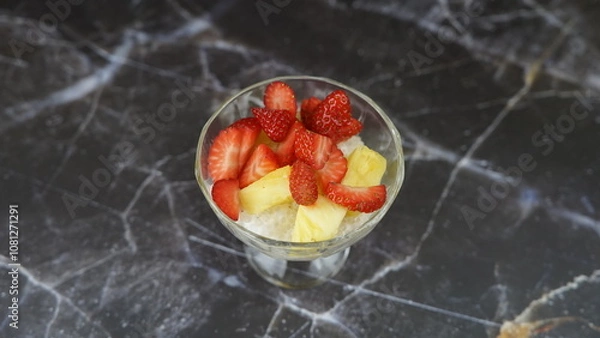 Fototapeta Dessert of tapioca balls with pineapple and mango in an ice cream cup